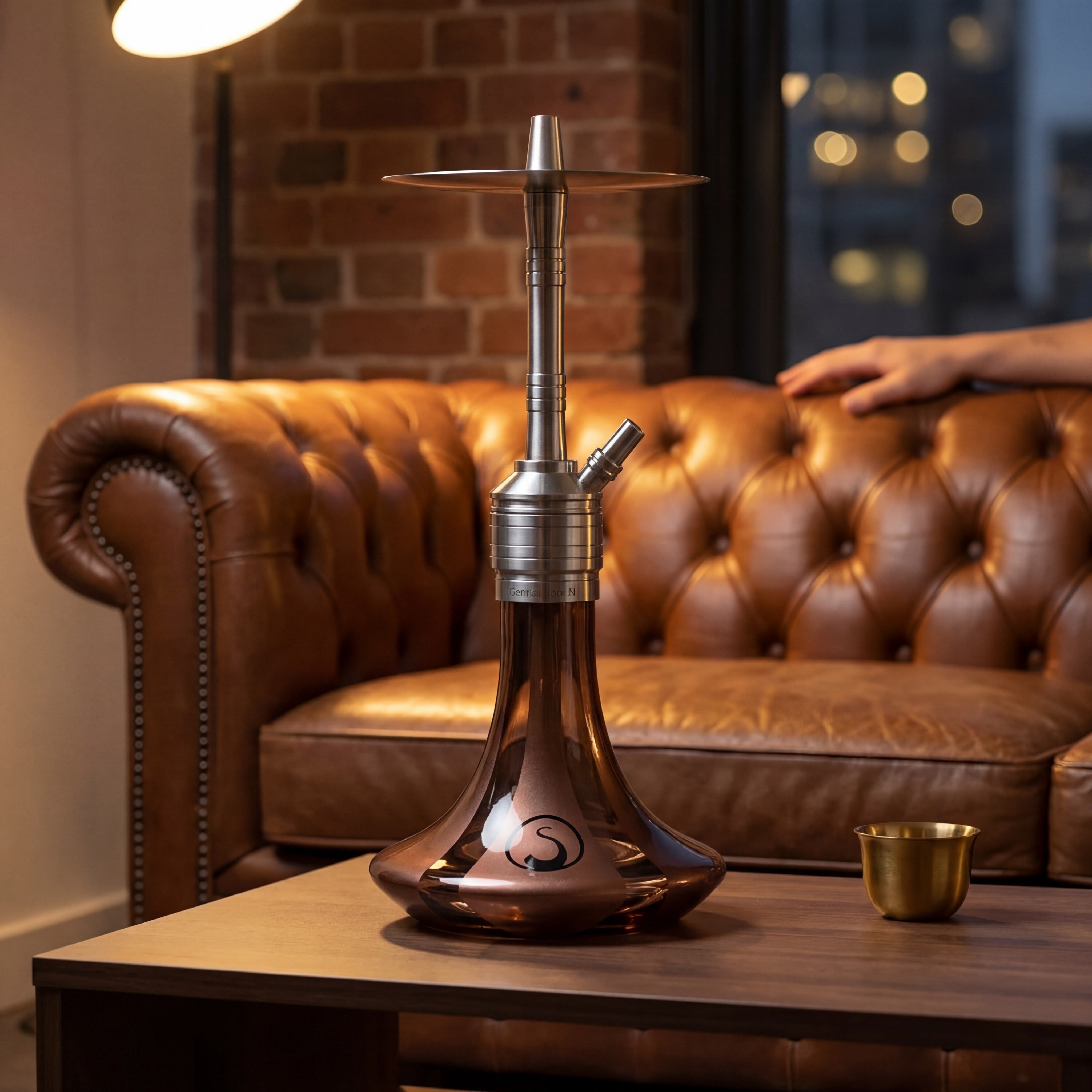 Steamulation Mini Gen II Copper Metallic hookah on walnut coffee table beside cognac leather chesterfield in Melbourne CBD apartment