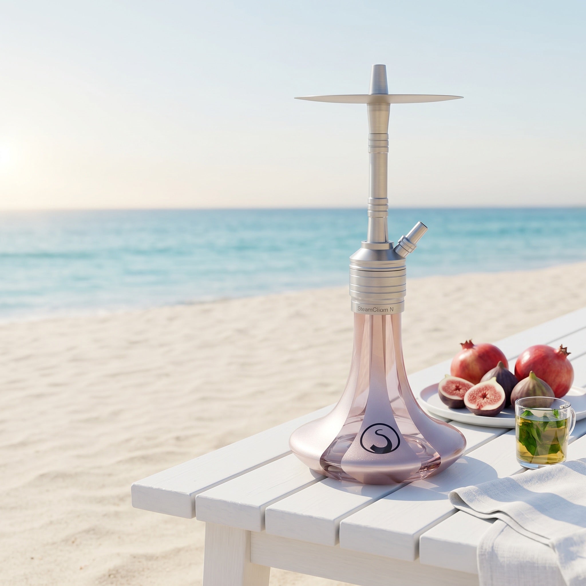 Steamulation Mini Gen II Rose Metallic hookah on white beach bench by turquoise ocean, figs and mint tea