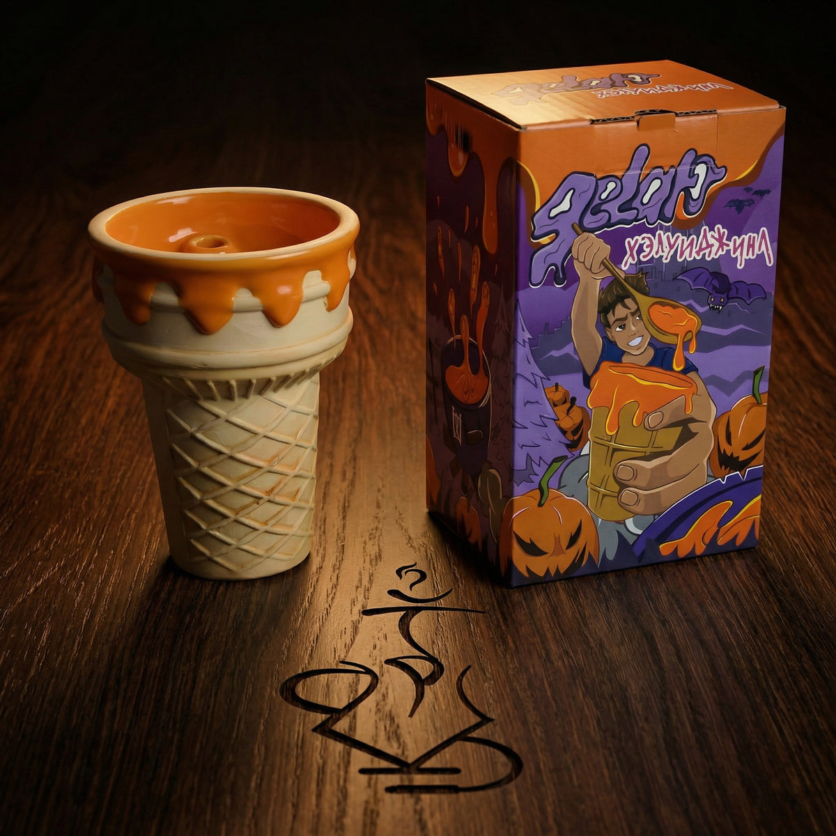 Werkbund Gelato Pumpkin Drip Halloween Edition bowl displayed beside its illustrated purple and orange collector's box on dark oak, a limited hand-numbered release available online from The Premium Way., image 4 of 10