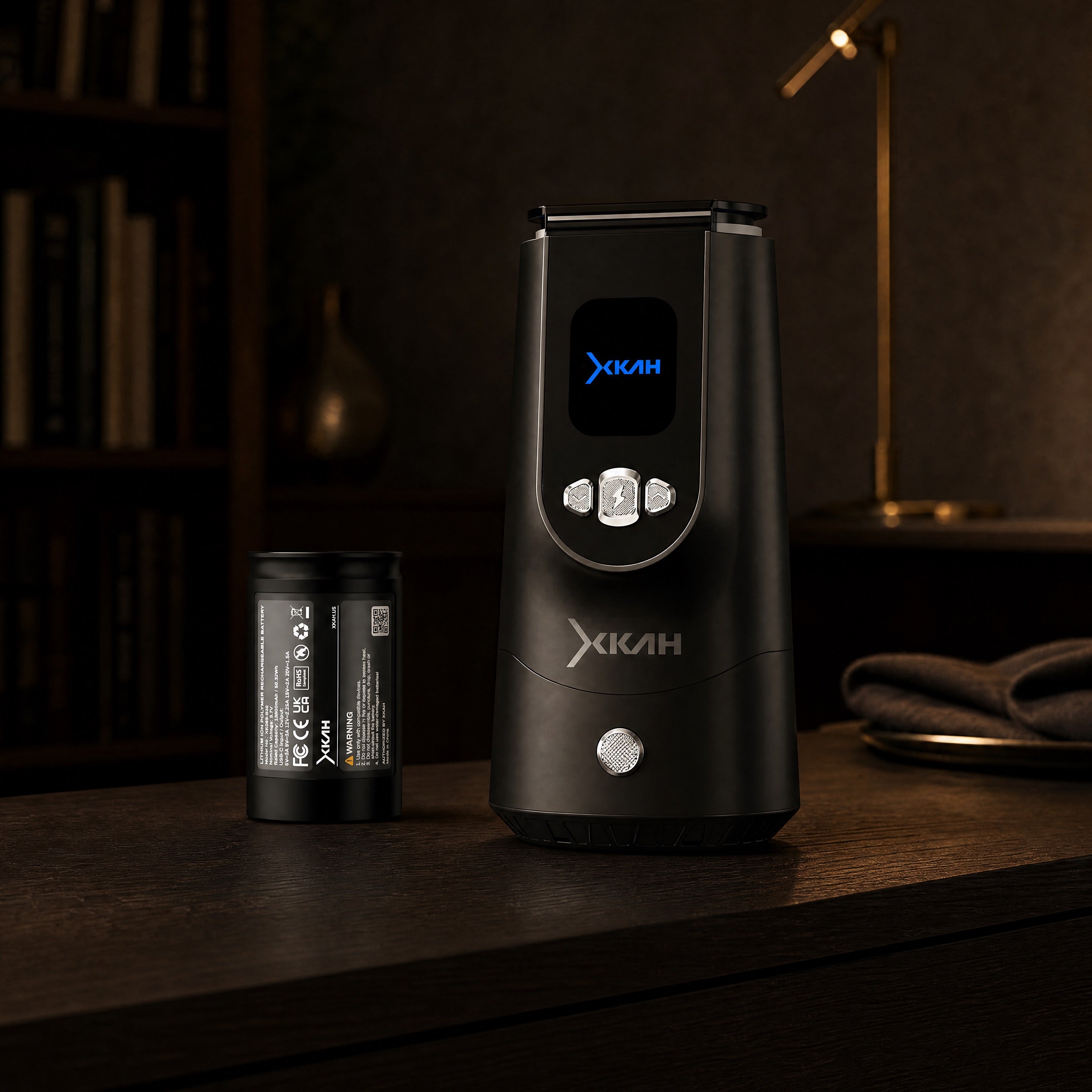 XKAH Pro eHMD on a modern home prep console at dusk with spare 13600 mAh battery beside it.