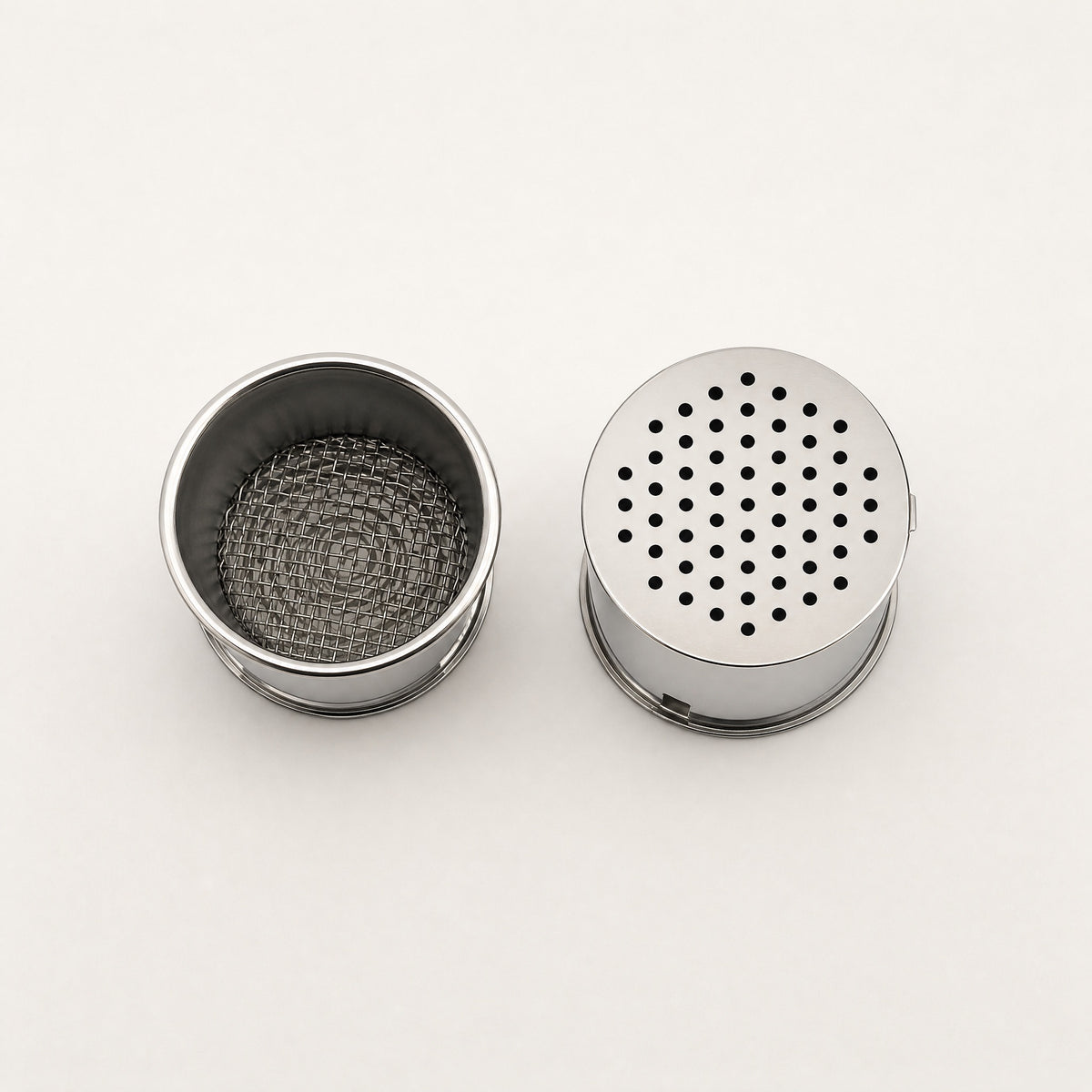 XKAH Pro shisha pod shown open with stainless mesh interior beside a closed pod with perforated lid in place., image 9 of 28