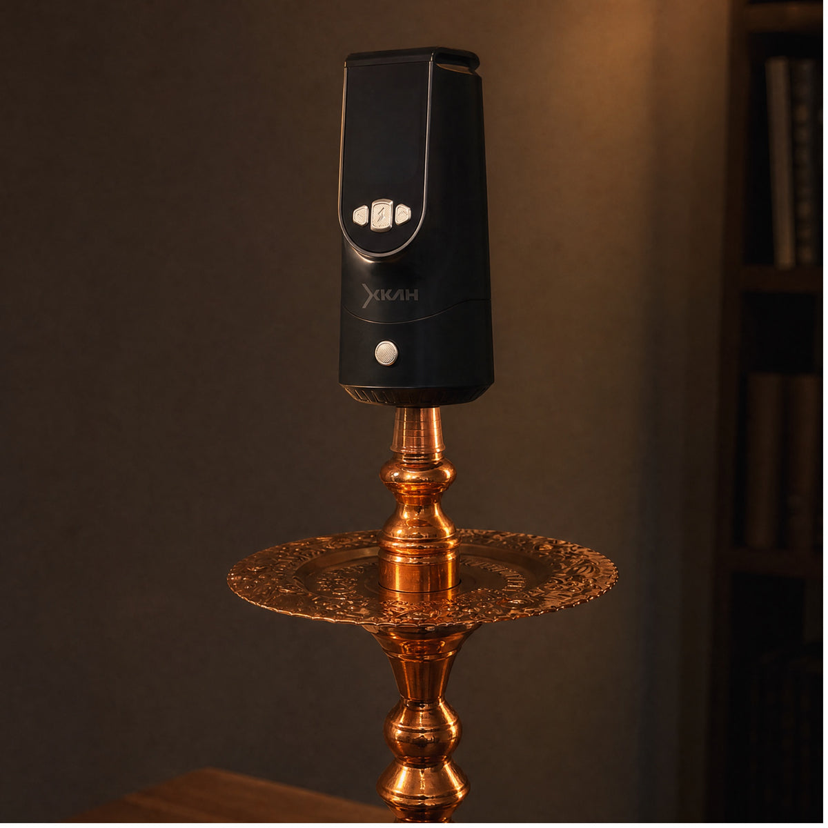 XKAH Pro seated on a traditional engraved brass hookah, confirming compatibility with heritage Egyptian-style shisha pipes., image 8 of 28