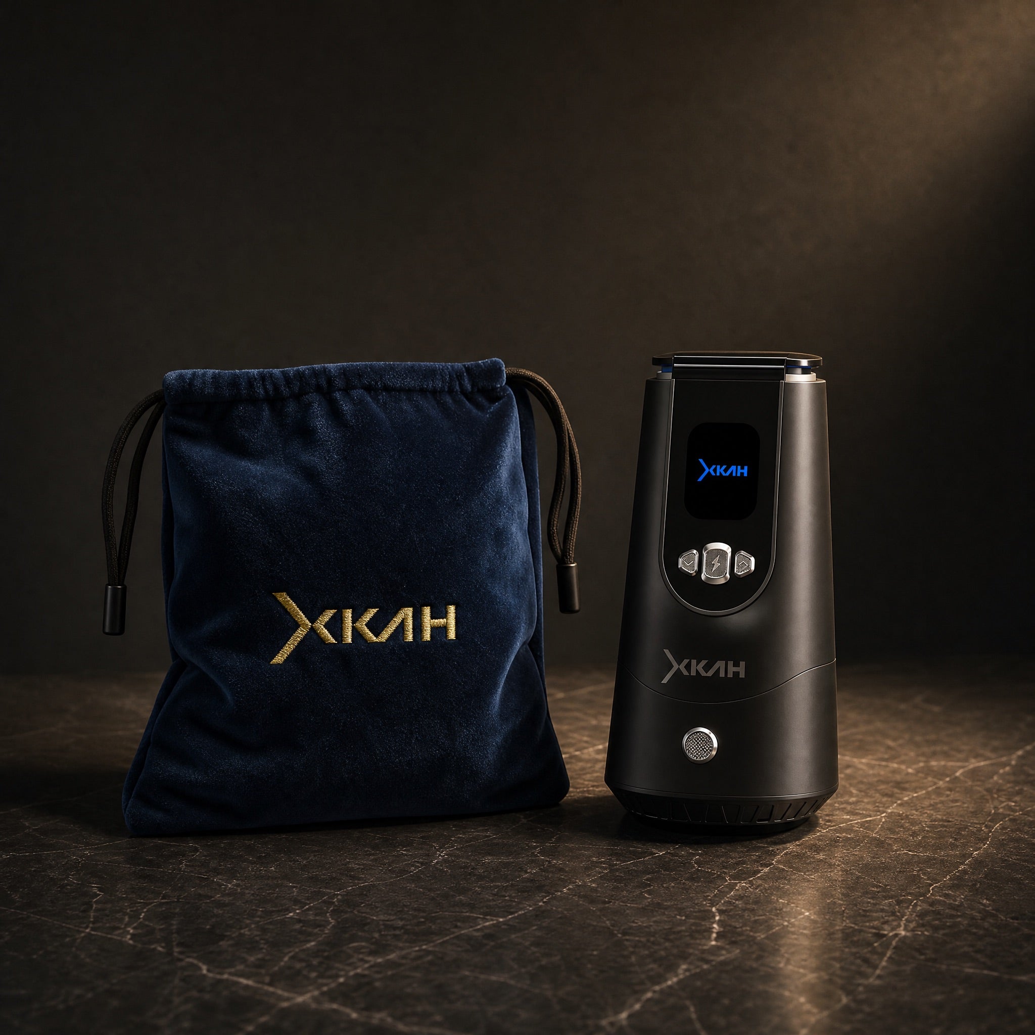 XKAH Pro electronic heat device with its navy velvet drawstring travel bag, on polished stone — travel-ready set.